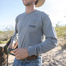 Load image into Gallery viewer, Man wearing a cowboy hat and long-sleeve shirt in a desert setting
